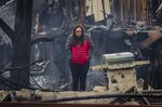 A woman takes in what remains of her cousin's condo in the aftermath of the Marshall Fire in Louisville, Colorado,&nbsp; Dec.&nbsp;31.