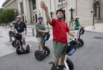 Adam Plescia of Capital Segway Tours leads a tour group riding Segway personal transporter vehicles in Washington, Aug. 28, 2009.
