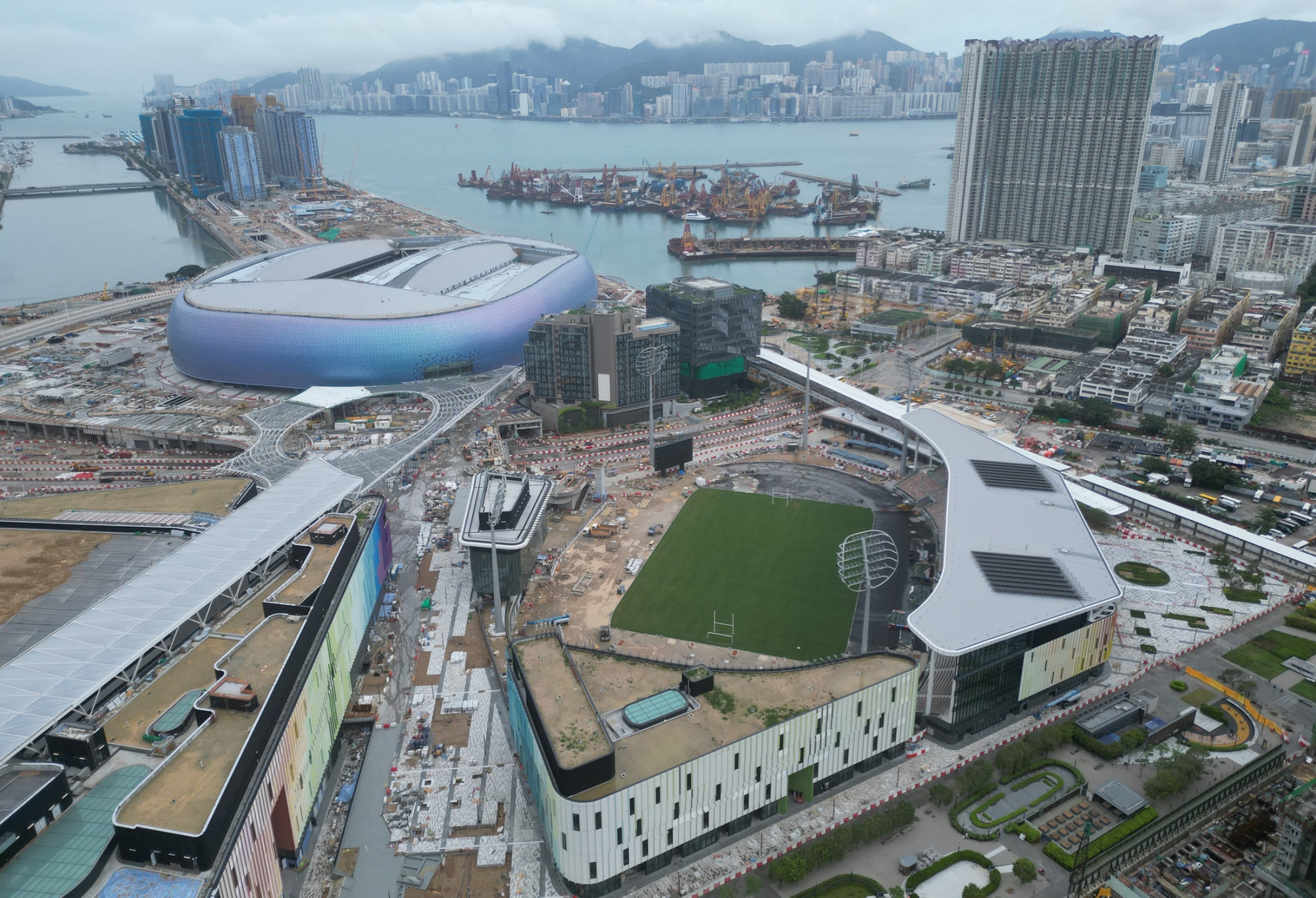 The stadium at Kai Tak has been delayed until next year; the former runway stretches out into Kowloon Bay.