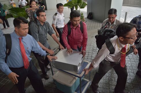Malaysian police seize equipment from the 1MDB office in Kuala Lumpur in July 2015.