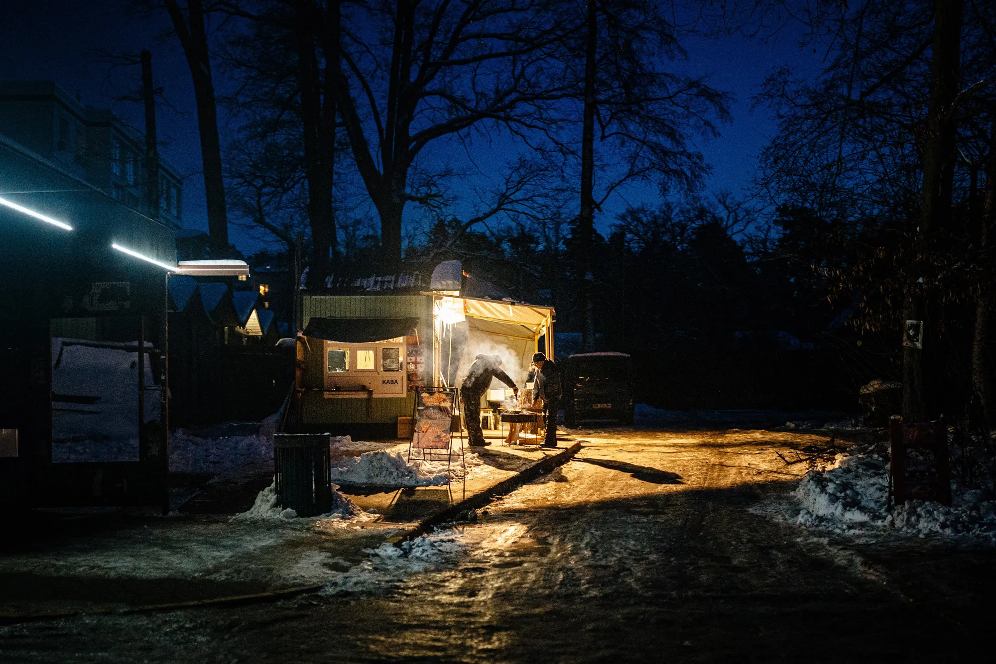Residents prepare food on a street in&nbsp;Irpin, near Kyiv. European leaders have accused Putin of weaponizing energy against Ukraine.