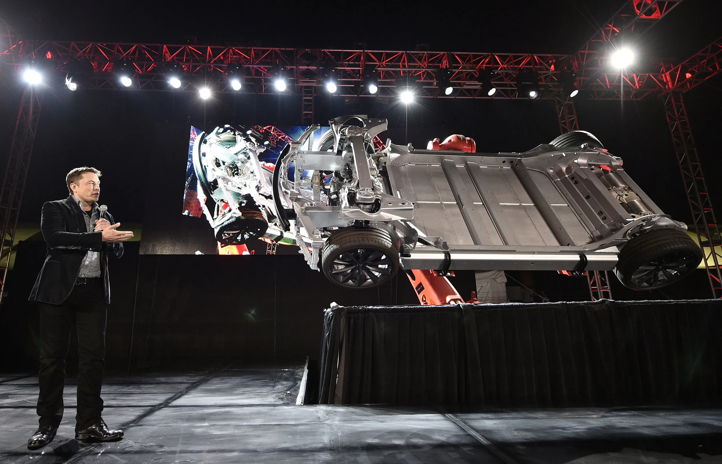 Elon Musk, CEO of Tesla, unveils the dual engine chassis of the new Tesla 'D' model at the Hawthorne Airport on Oct. 9, 2014.
