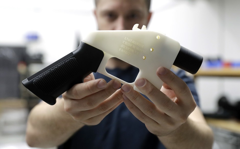 Defense Distributed founder Cody Wilson with his &quot;Liberator,&quot; a 3-D printed pistol made of plastic.