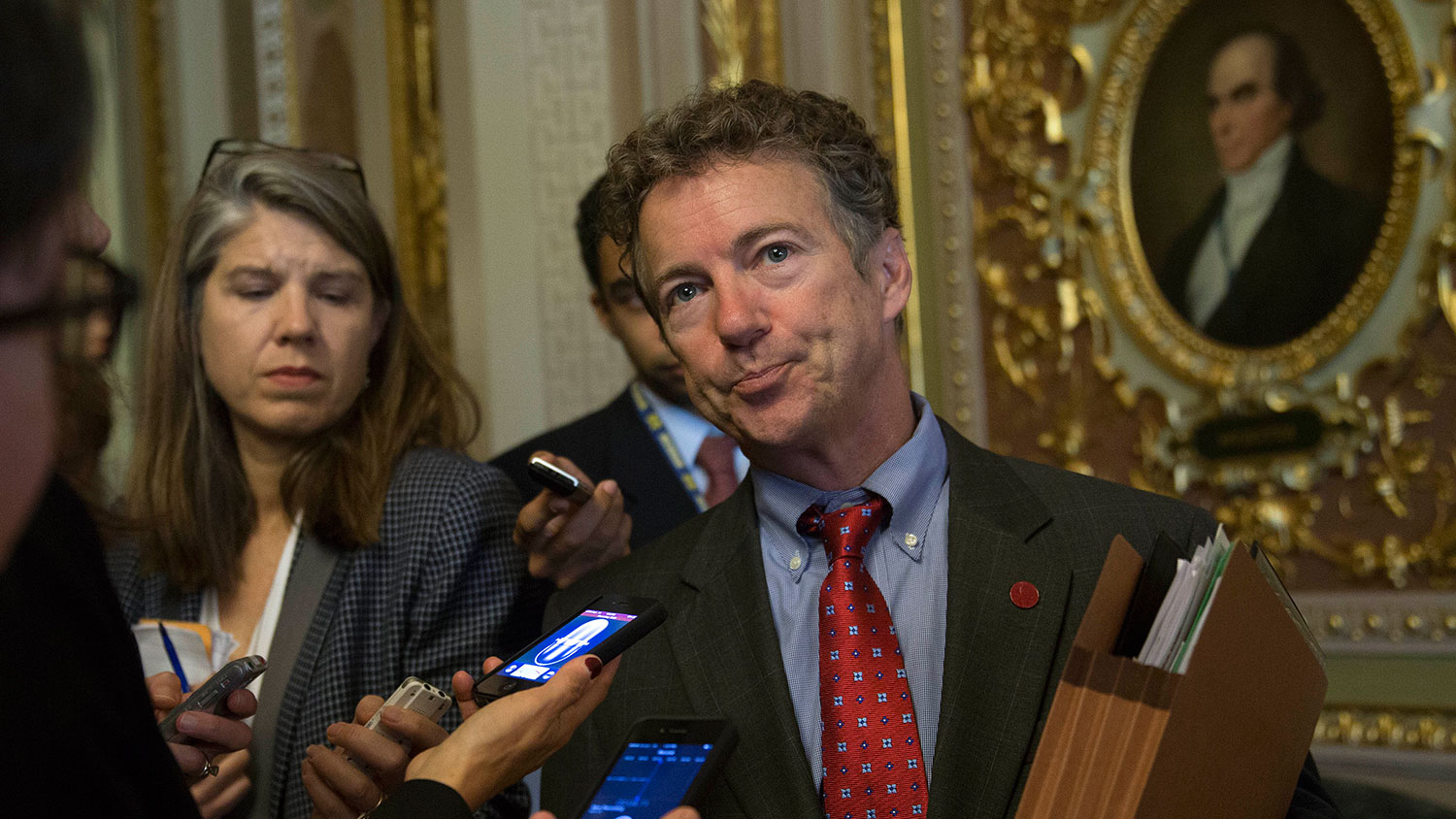 Senator Rand Paul, a Republican from Kentucky, talks to reporters before walking into the Senate Chamber in Washington, D.C., U.S., on Friday, Sept. 27, 2013.
