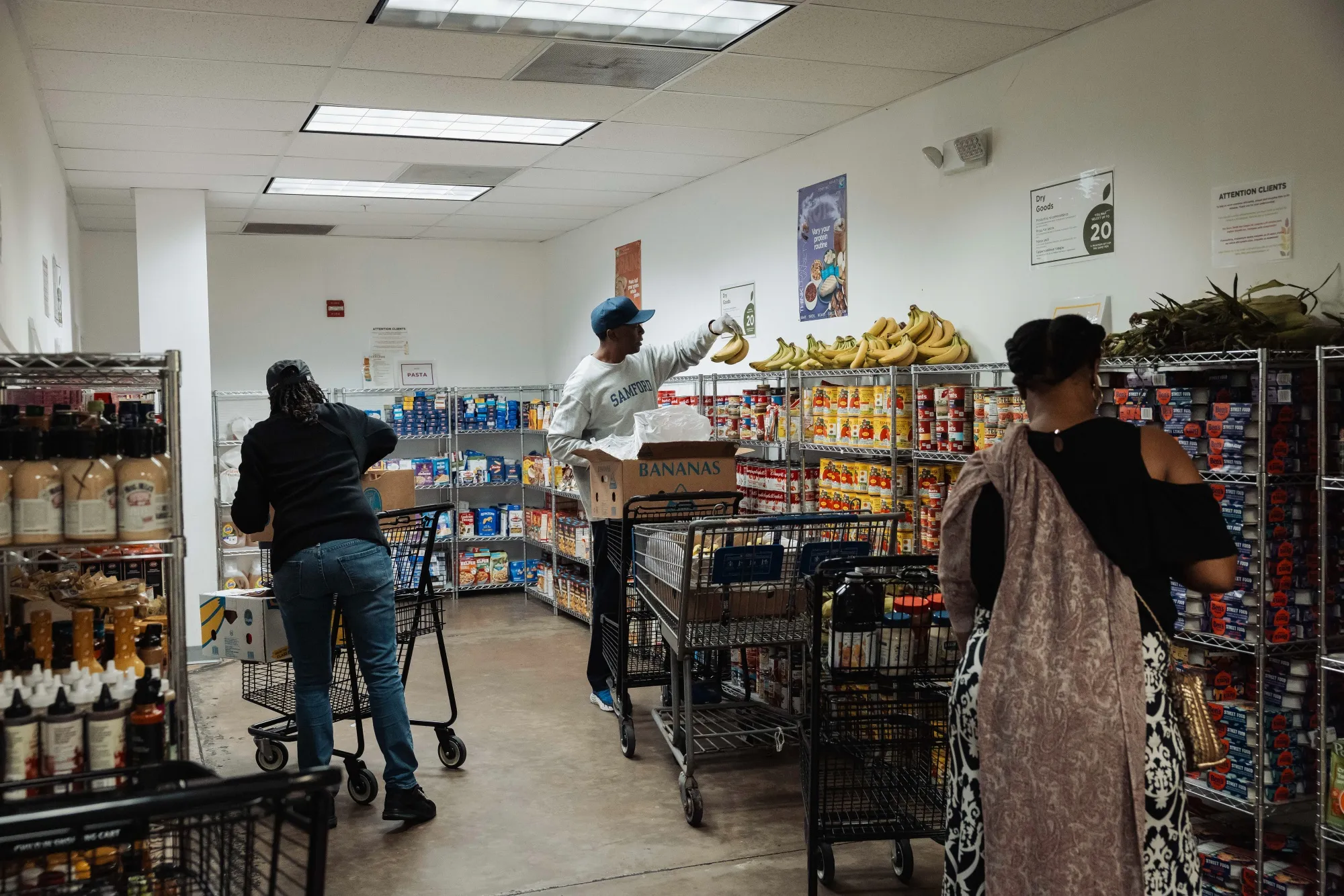 Volunteers restock donated food items in the pantry at Feeding South Florida in Pembroke Park, Florida.