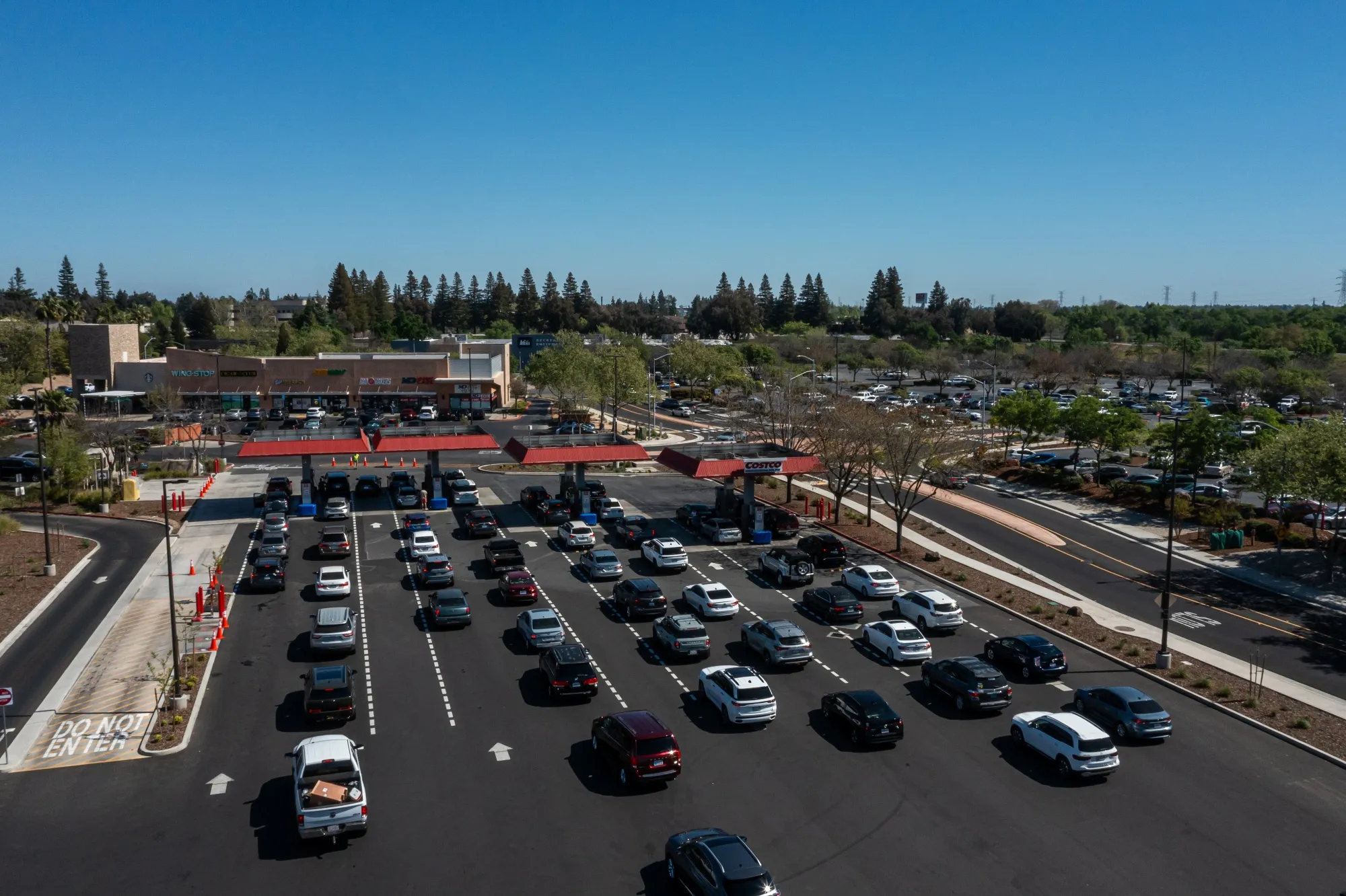 Drivers wait to refuel vehicles at a gas station in Sacramento, California.