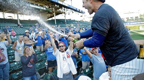 Anthony Rizzo #44 of the Chicago Cubs celebrates with fans after clinching their wildcard playoff position at Wrigley Field on Sept. 26, 2015 in Chicago, Illinois.