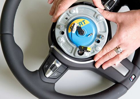 A worker shows an air bag initiator at Takata Ignition Systems in Schoenebeck, Germany, on April 17, 2014.