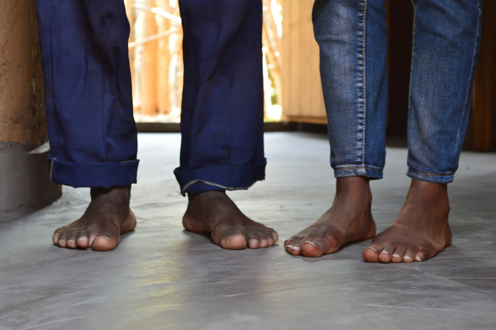Rwandan children on the flaxseed oil floor that replaced the former dirt base.&nbsp;