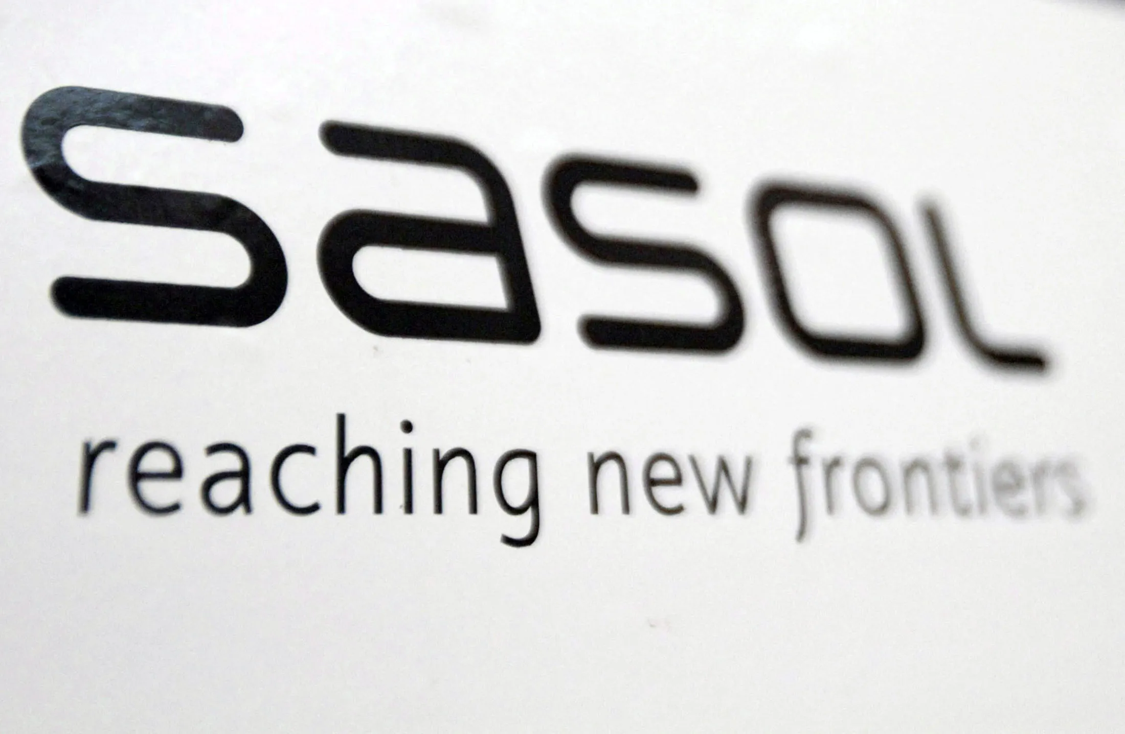 Sasol Ltd. branding is displayed at the company's offices in Johannesburg, South Africa, on Monday, Sept. 13, 2010. Sasol Ltd., the largest producer of motor fuels made from coal, beat analysts' earnings estimates and raised its dividend payment by 24 percent after increasing production and cutting costs.
