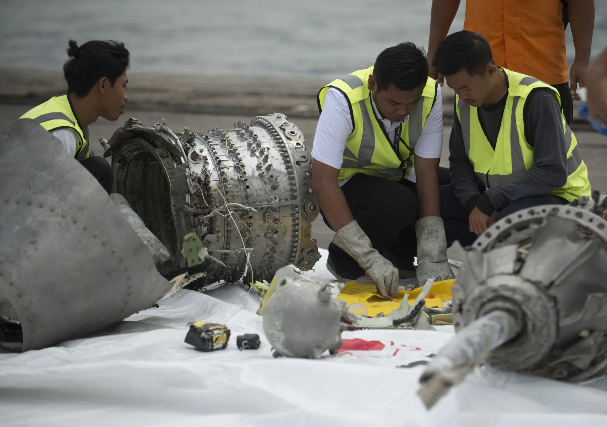 Investigators examine engine parts from Lion Air flight JT 610, Nov. 2018.