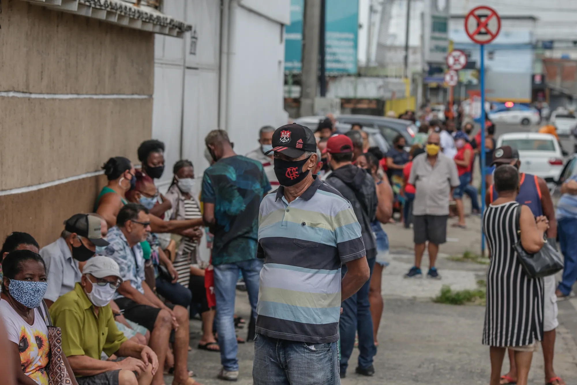 People wait in line to get vaccinated outside of a clinic in Rio de Janeiro.