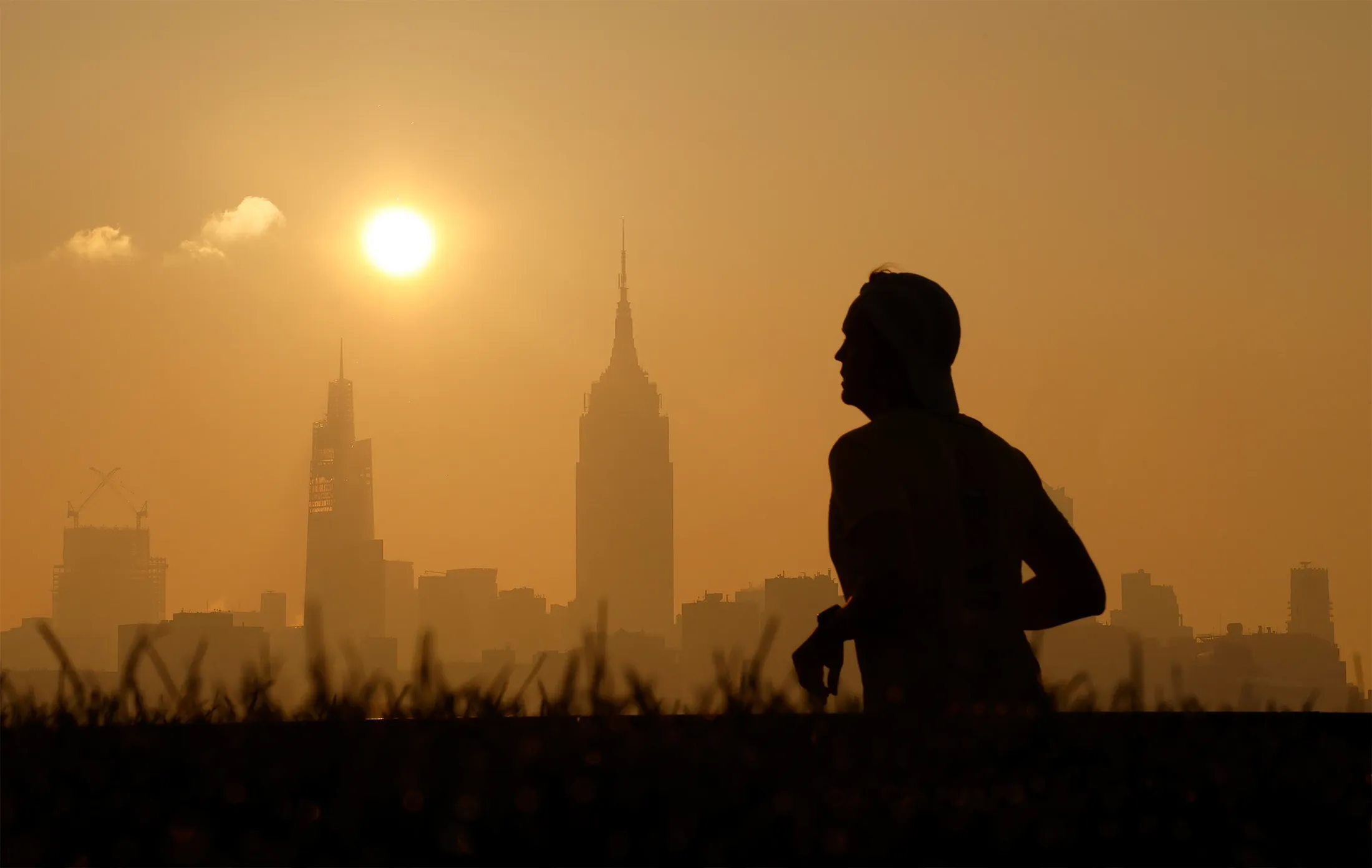 Haze shrouds the skyline of midtown Manhattan&nbsp;as the sun rises in New York City on July 5.