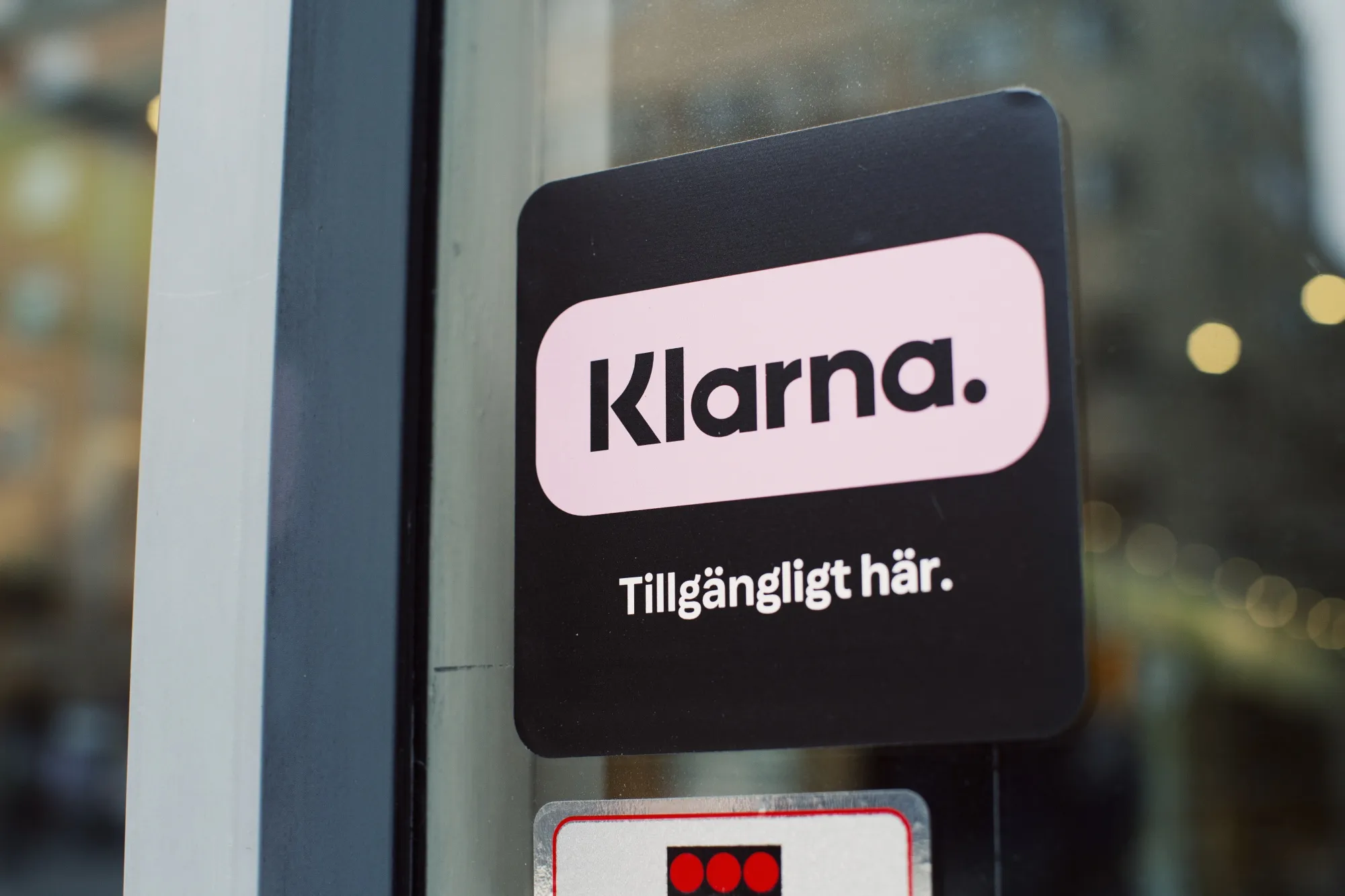 A sticker in the window of a shop which reads "Klarna Available Here" in Stockholm.