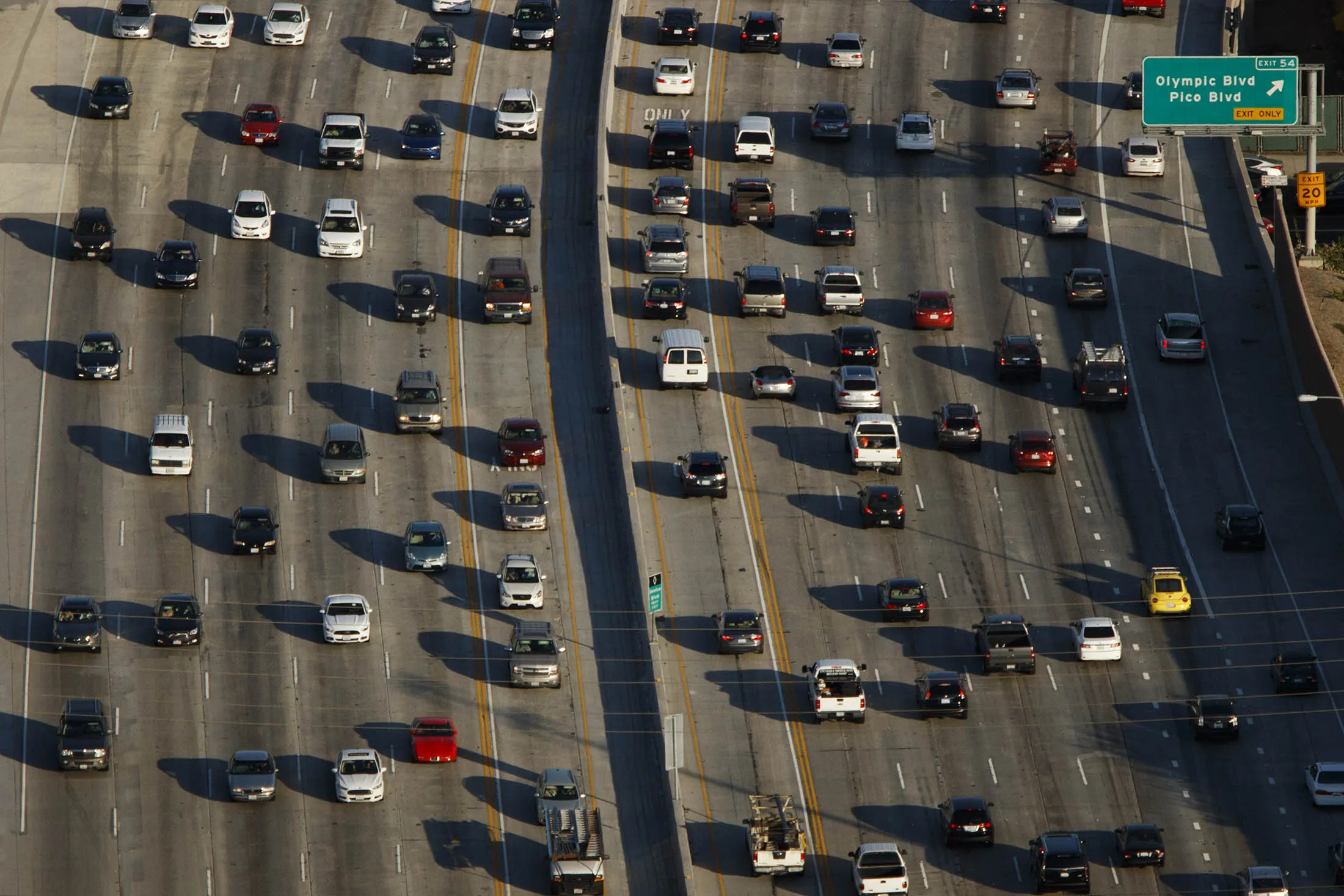Cars sit in rush hour traffic on the 405 Freeway at Olympic Blvd in this aerial photograph taken over Los Angeles.
