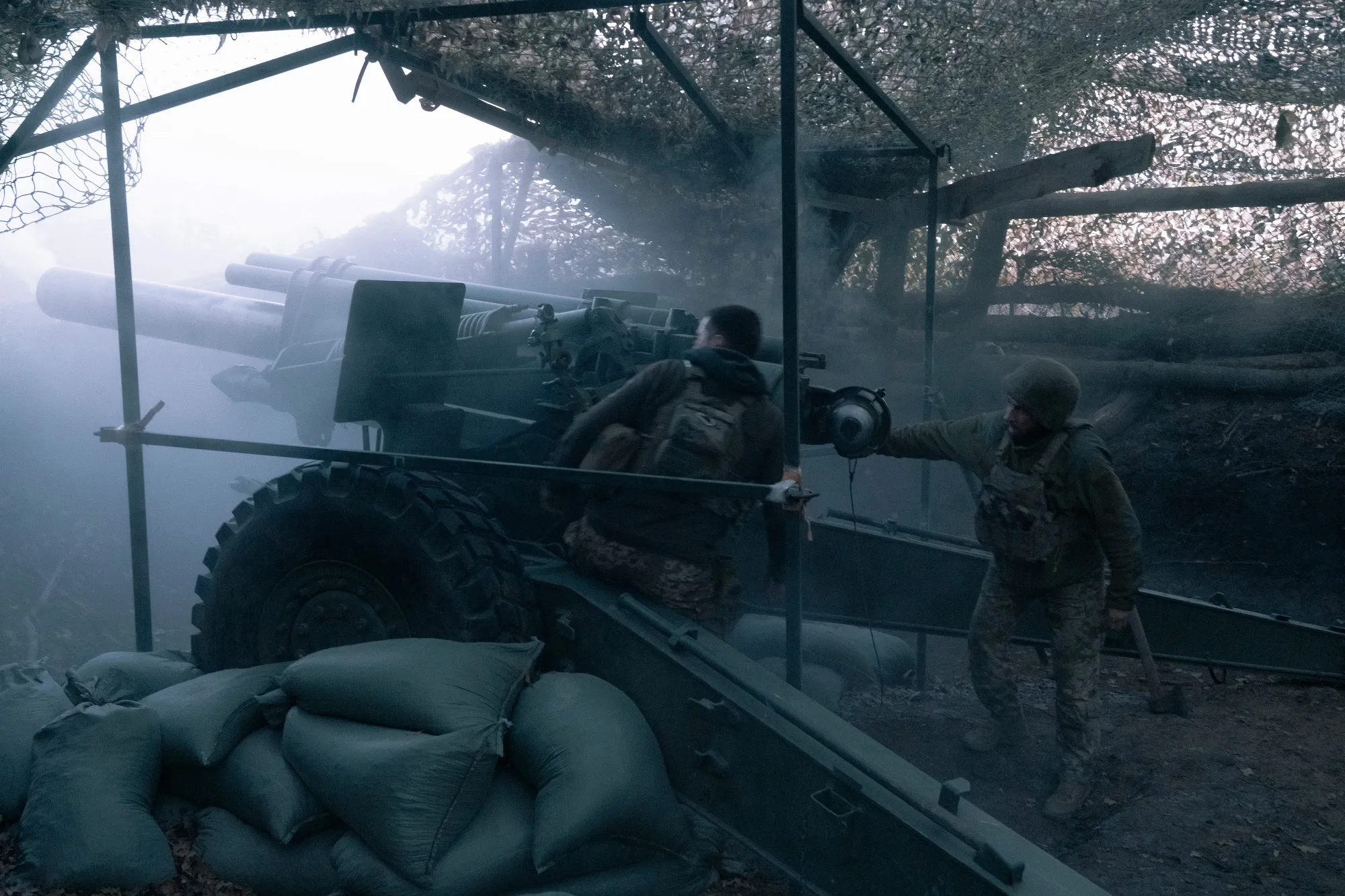 Ukrainian soldiers of the 152nd Separate Grenadier Brigade operate a howitzer on Oct. 16, near Pokrovsk.