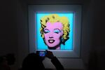 A guest takes a photo of Andy Warhol’s “Shot Sage Blue Marilyn”&nbsp;at Christie’s in New York on March 21.