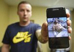 Paul Wright shows a picture of himself in the hospital after a near fatal overdose in 2015, Thursday, June 15, 2017, at the Neil Kennedy Recovery Clinic in Youngstown, Ohio.