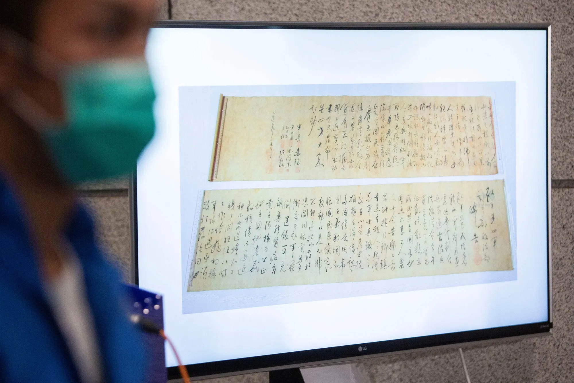 Police show a picture of a calligraphy scroll written by Mao Zedong which was torn in half, in Hong Kong on Oct. 7.