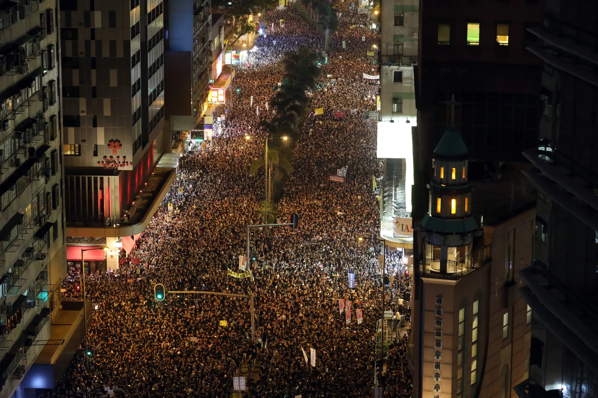 Protesters march at night during a rally in Hong Kong, China, on Sunday, June 16, 2019. Tens of thousands of demonstrators poured into central Hong Kong as organizers remained defiant even after the city’s leader suspended consideration of the China-backed extradition plan that sparked some of the biggest protests in the city in decades.