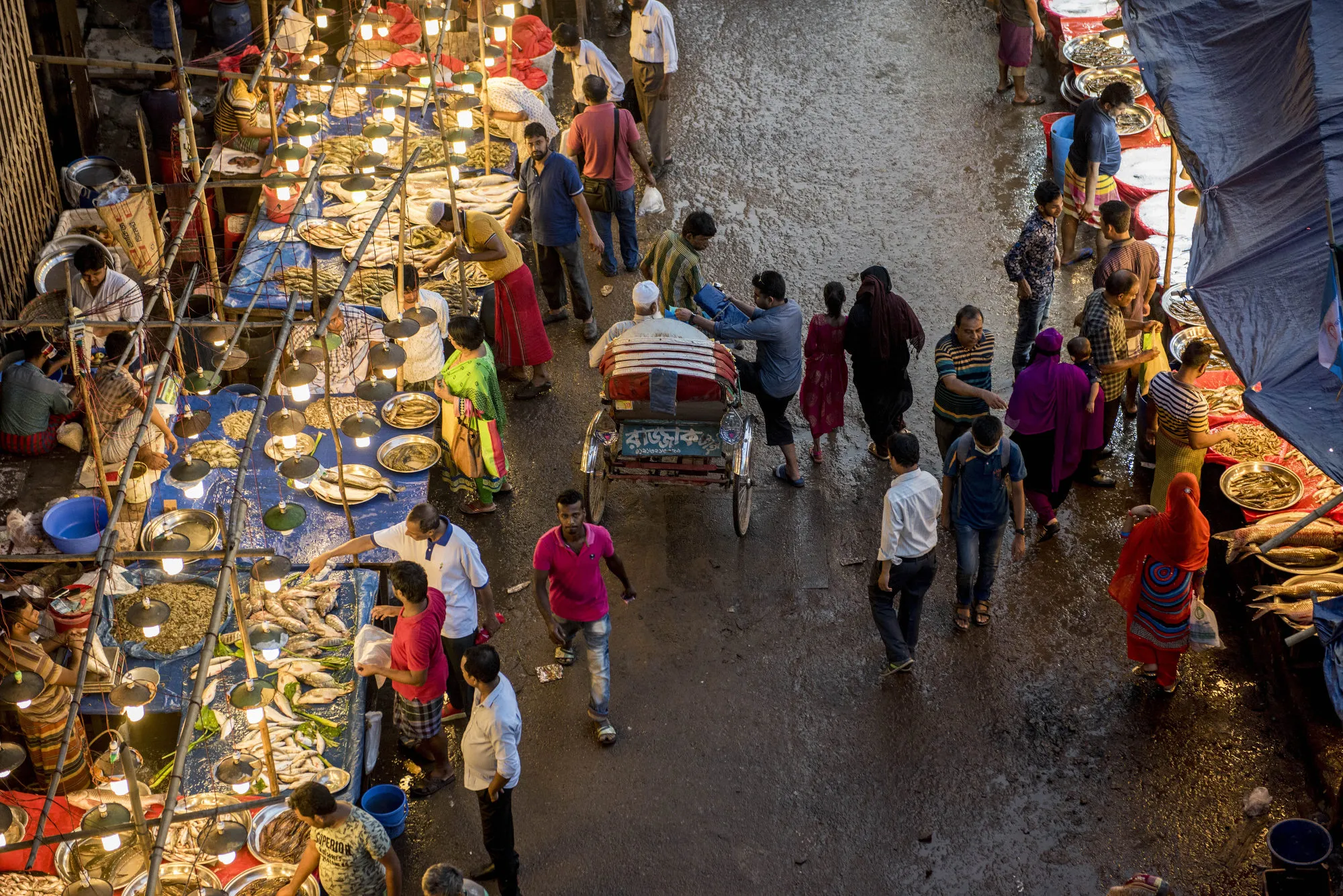 Customers browse a market in Dhaka, Bangladesh.