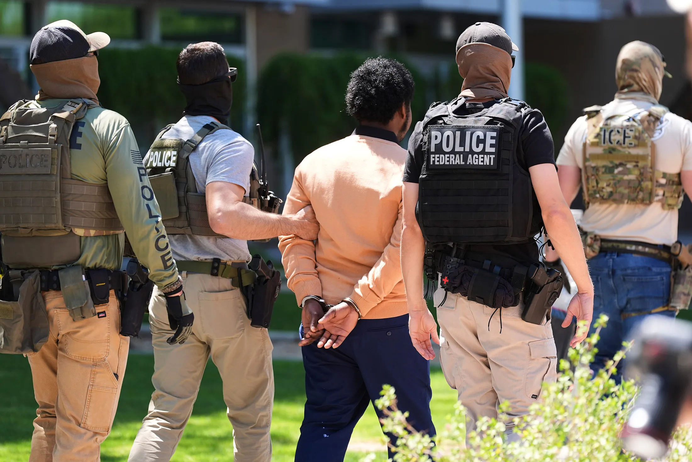 Federal agents take a person into custody outside an immigration court in Phoenix on May 21.