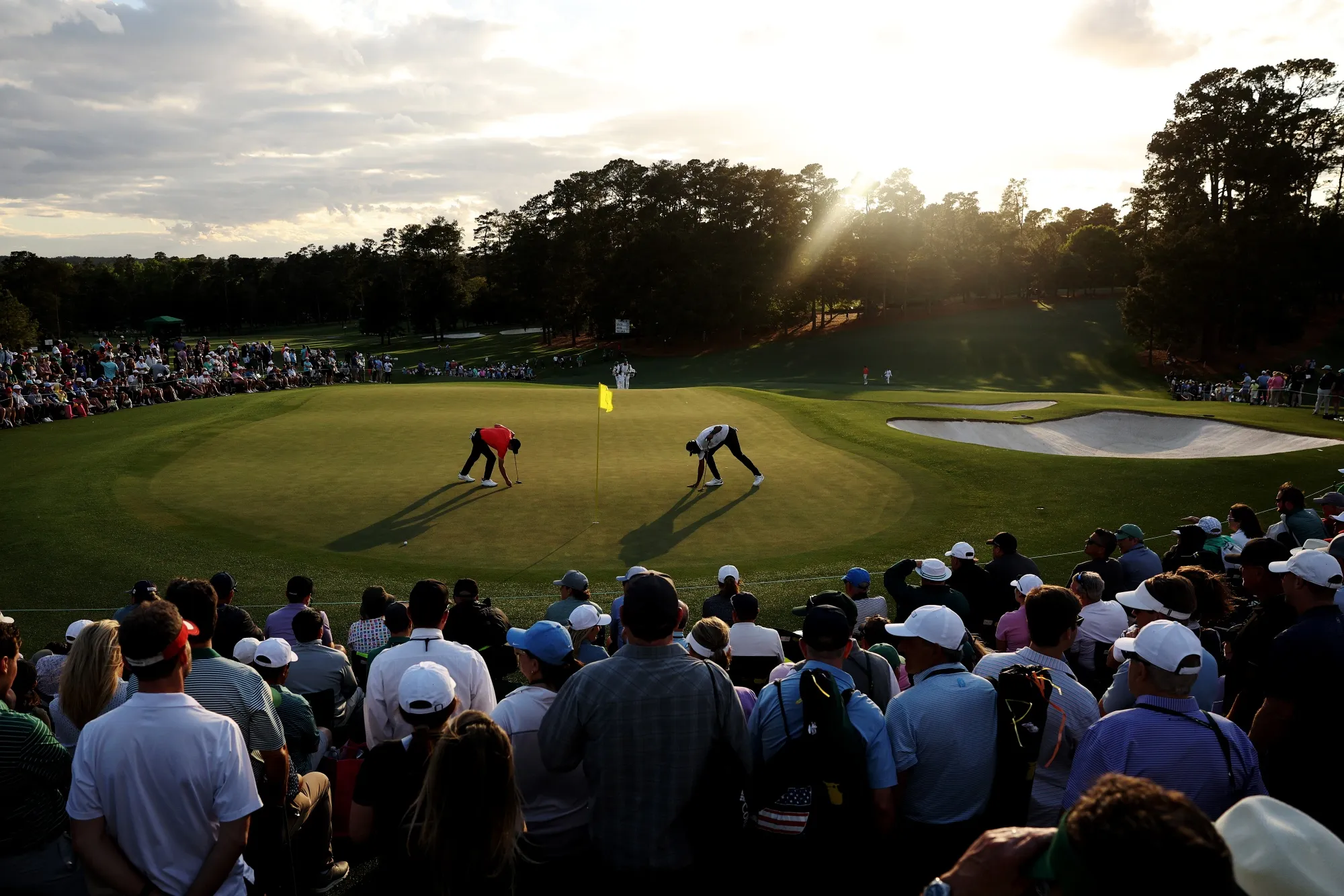Jordan Spieth and Sahith Theegala mark their ball on the ninth green during the first round of the 2024 Masters Tournament at Augusta National Golf Club in Augusta, Georgia on April 11.