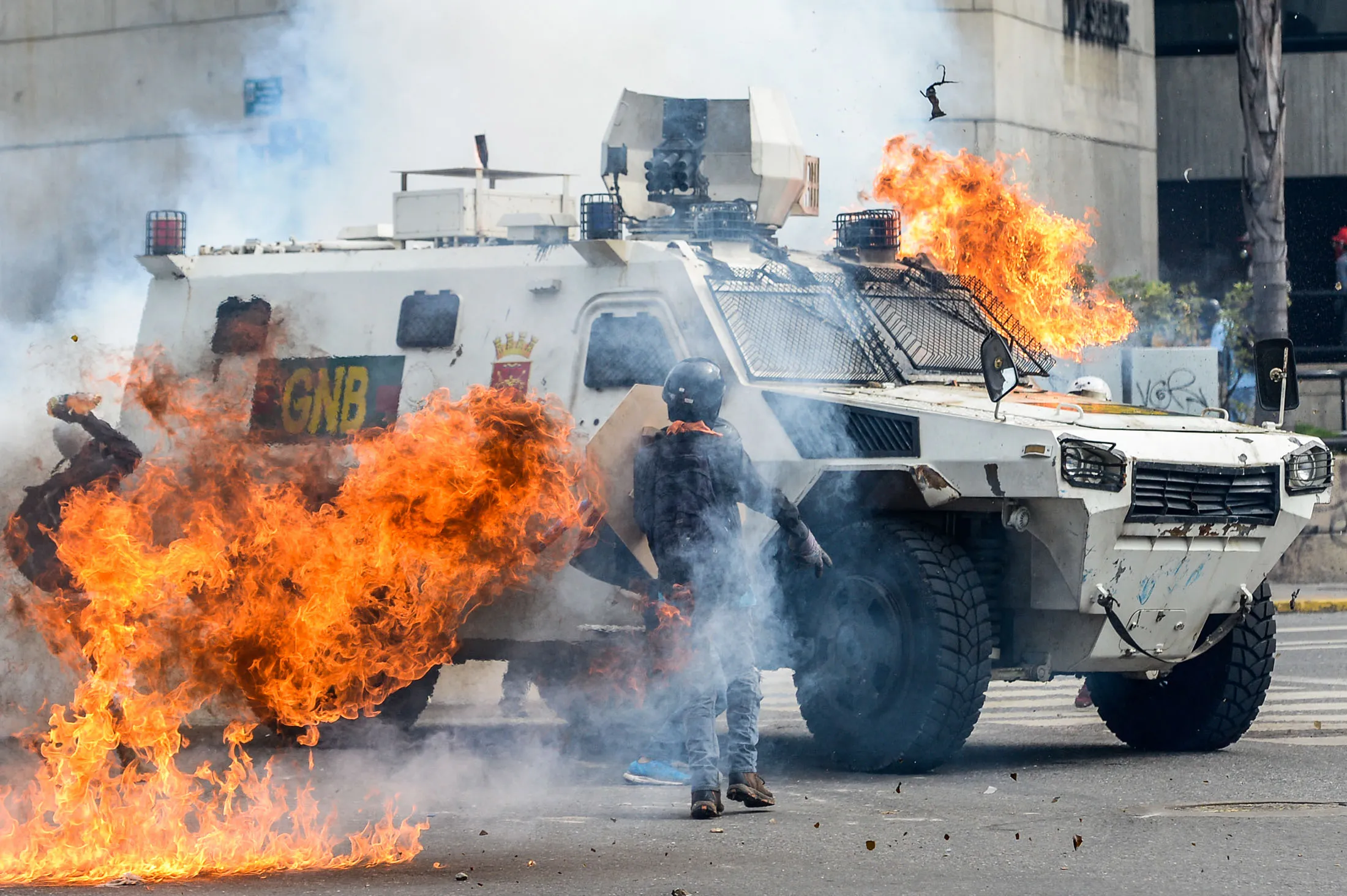 Demonstrators assault and set on fire a National Guard riot control vehicle during a protest against Venezuelan President Nicolas Maduro in Caracas on May 3.
