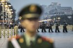 Chinese People's Liberation Army ceremonial guards cross Changan Avenue during a flag lowering ceremony at Tiananmen Square in Beijing, China.