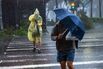 People cross a street as Typhoon Krathon makes landfall on in Kaohsiung, Taiwan, on Oct. 3.