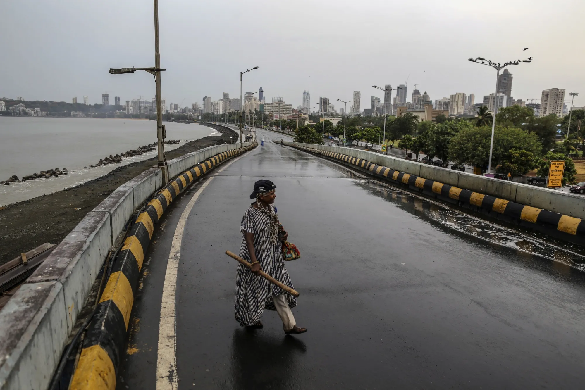 A pedestrian crosses the road at an empty Marine Drive during a lockdown in Mumbai, June 1.