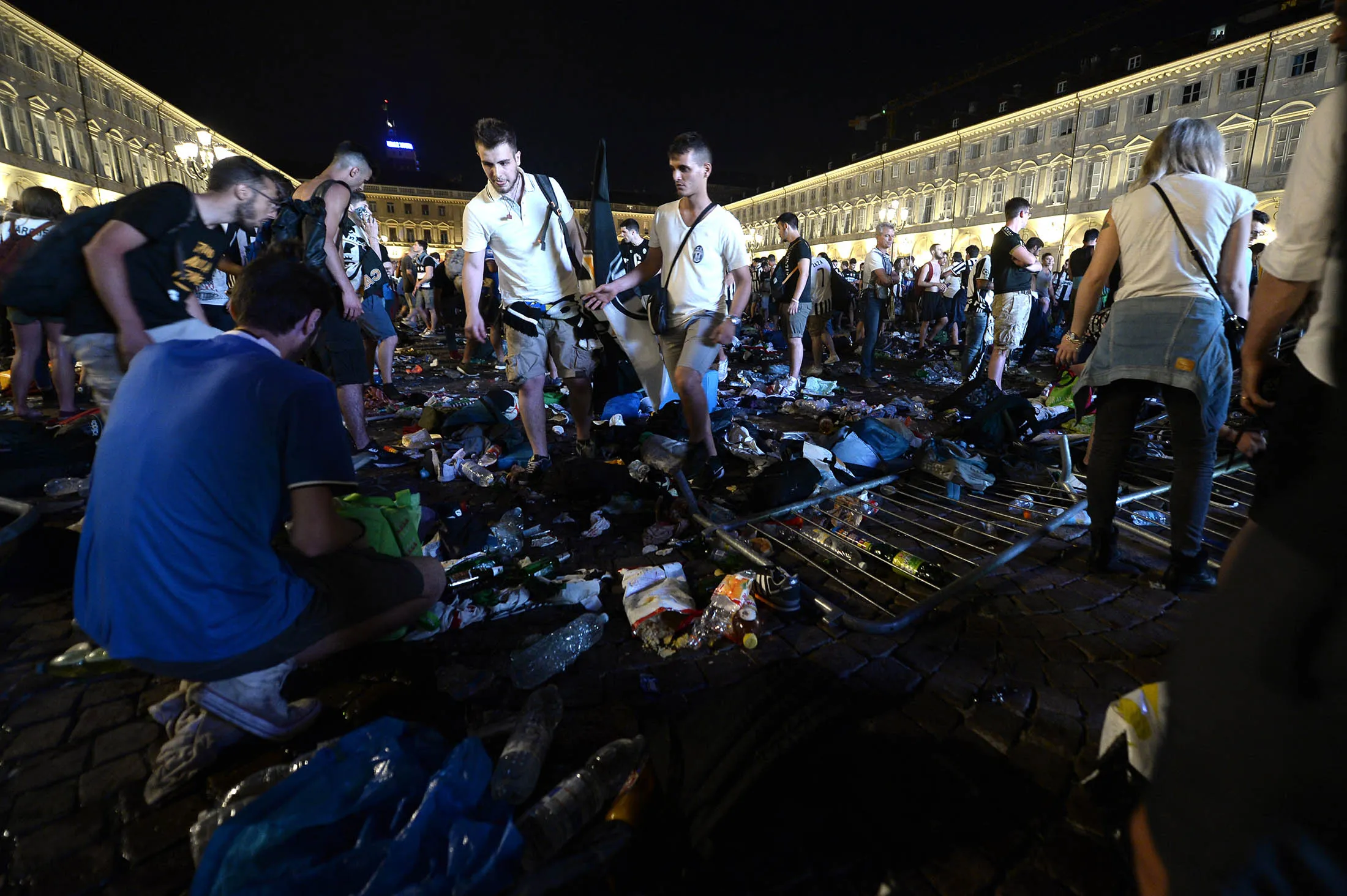 Juventus supporters look for personal belongings following a stampede at Piazza San Carlo, where thousands of Juventus fans were watching the UEFA Champions League Final football match on June 3.
