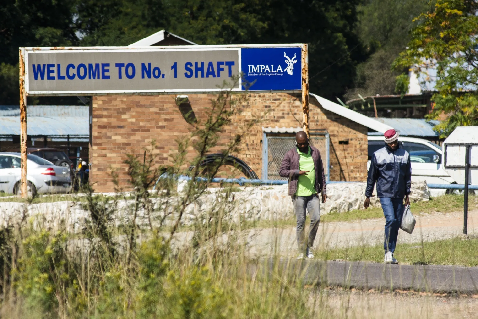 Workers depart following a shift change at the Impala shaft 1 mine in Rustenburg, South Africa.