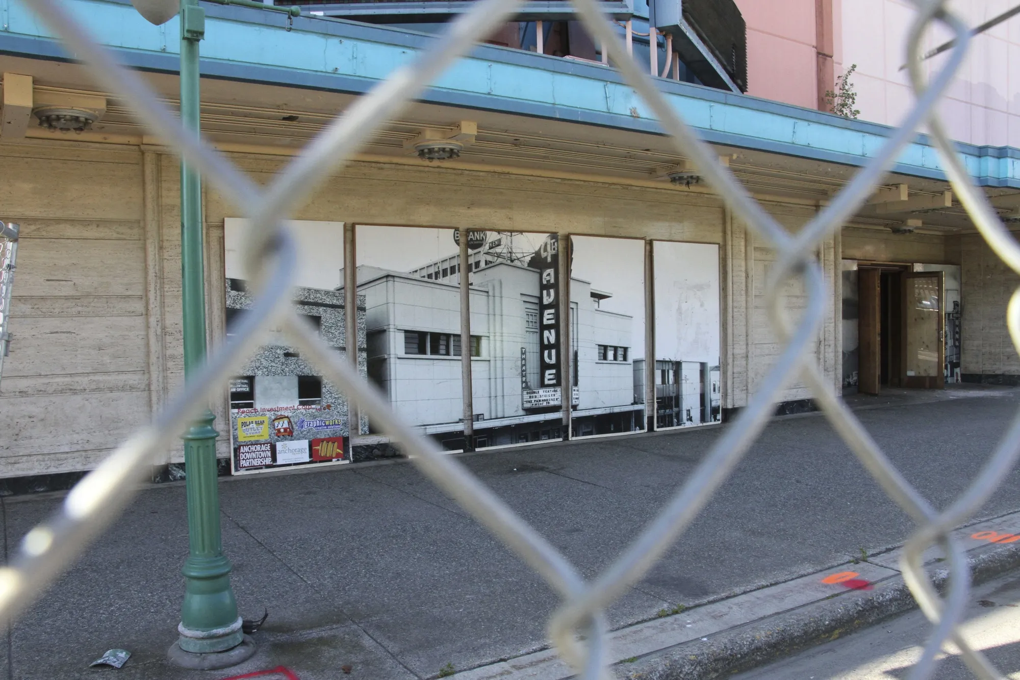 ** HOLD FOR STORY ** Fencing surrounds the 4th Avenue Theatre in Anchorage, Alaska, on Wednesday, Aug. 3, 2022. Demolition will begin in August 2022 on the once-opulent downtown Anchorage movie theater designed by the architect of Hollywood's famed Pantages Theatre. The 4th Avenue Theatre with nearly 1,000 seats opened in 1947, and it withstood the second most powerful earthquake ever recorded. (AP Photo/Mark Thiessen)