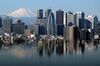 Mount Fuji and buildings in the Shinjuku district are reflected on a table at an observation deck in Tokyo, Japan.