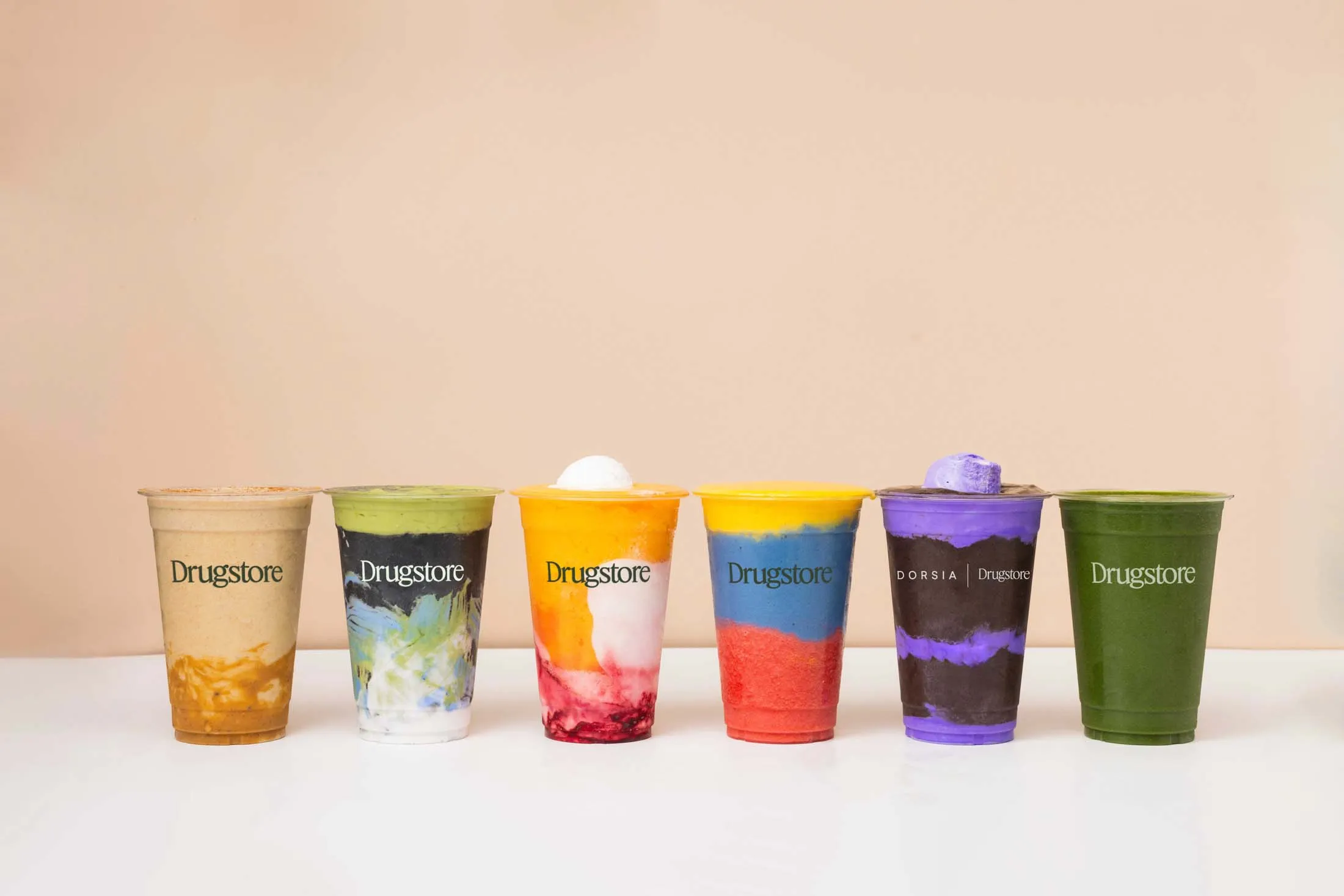 A lineup of Drugstore smoothies; the VIP $20 Velvet Rope is the purple and brown order, second from right.