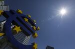 The sun shines on the euro sign sculpture outside the former European Central Bank (ECB) headquarters in Frankfurt, Germany.