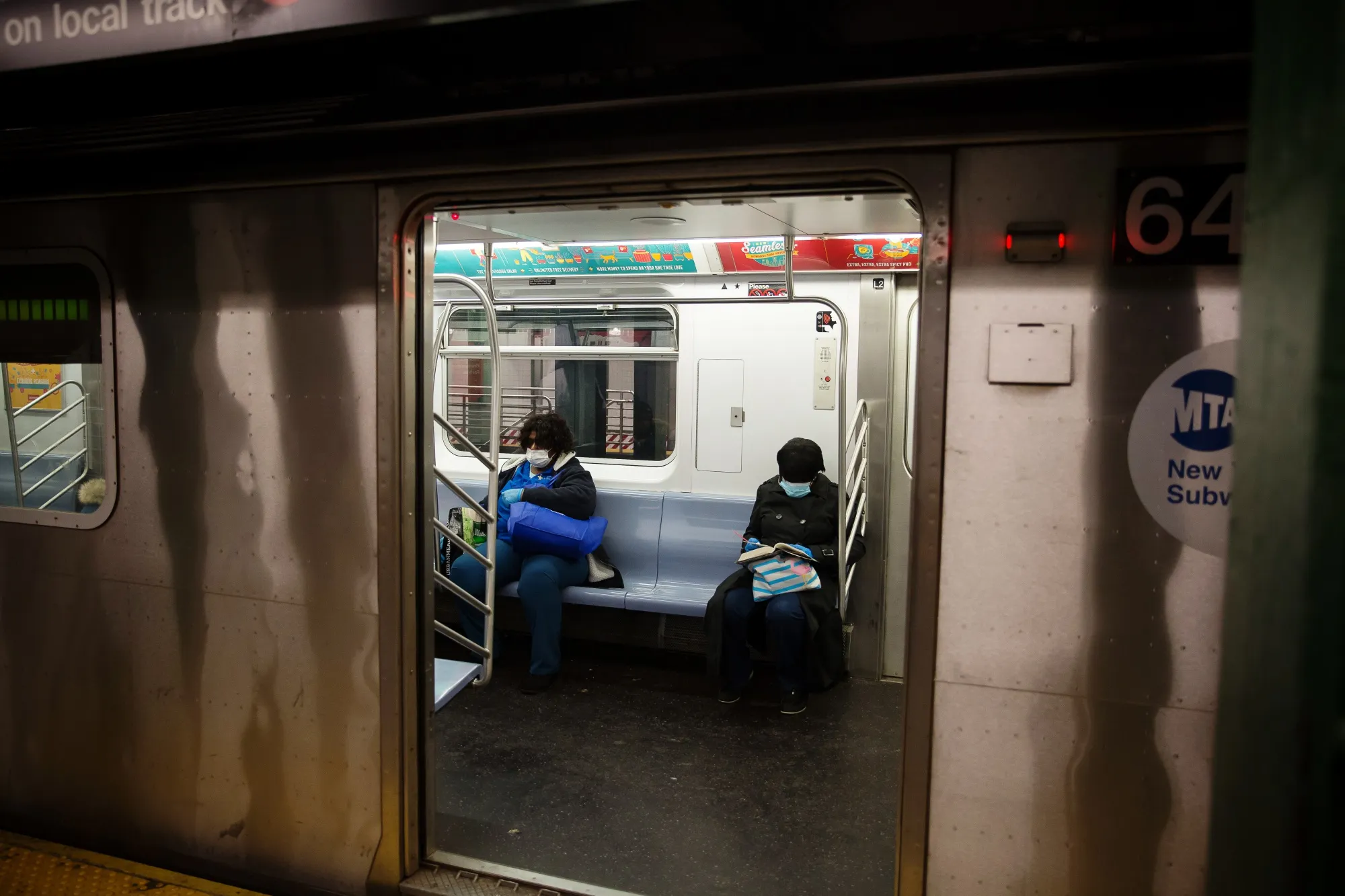 Passengers wear protective masks on the subway in New York on March 30.