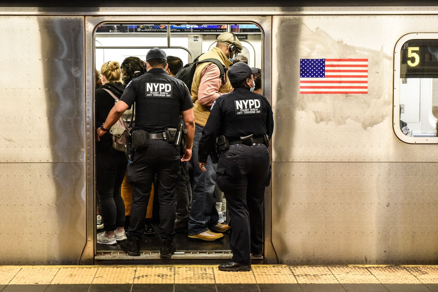 New York Police Department officers enter a subway in New York City. 