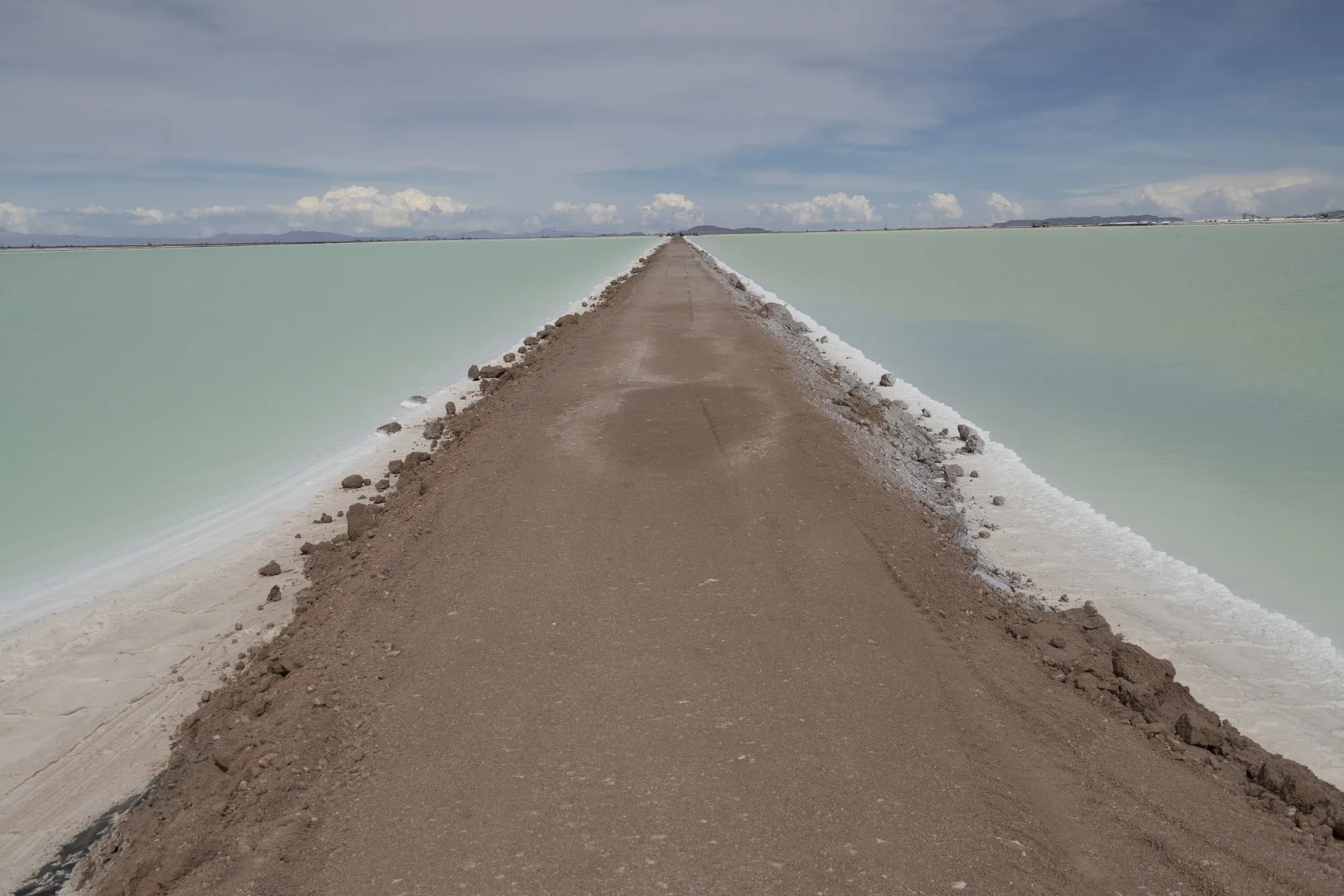 A road between two industrial evaporation pools at a lithium production facility in the Uyuni Salt Flats in Potosi, Bolivia.