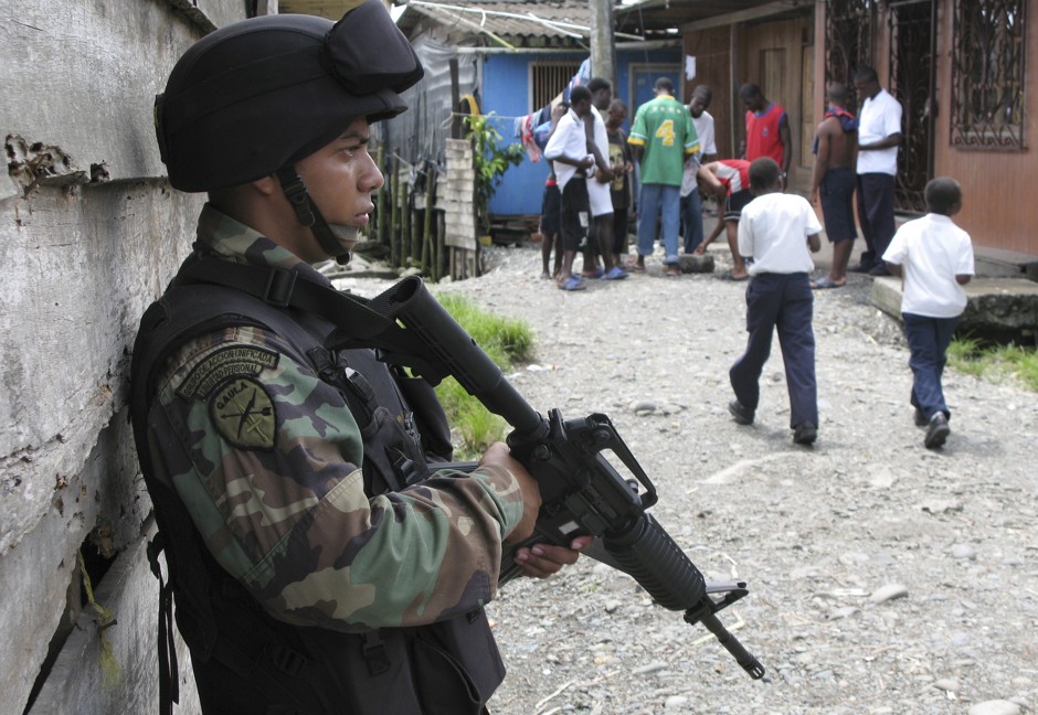 A Colombian soldier stands guard in a slum in Buenaventura.