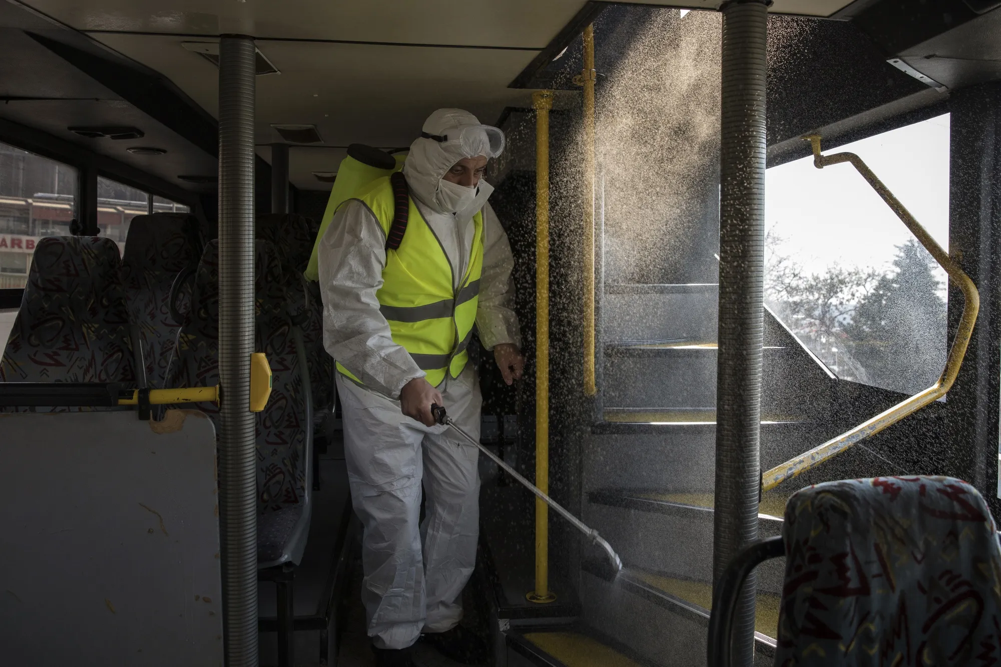 A Metropolitan Municipality worker&nbsp;sprays disinfectant on a bus&nbsp;in Istanbul, Turkey, on&nbsp;March 14.&nbsp;