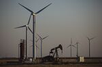 A pump jack stands next to wind turbines near Guymon, Oklahoma, U.S., on Friday, Sept. 25, 2020.&nbsp;