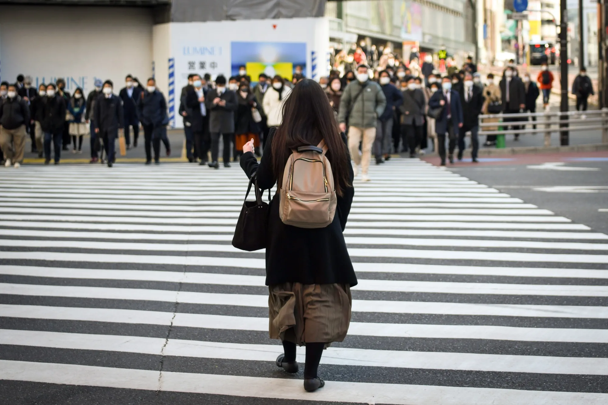 Commuter pass through the Shinjuku district in Tokyo.
