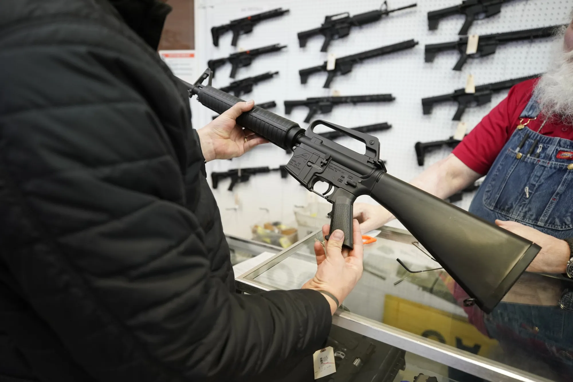 A salesperson shows an AR-15 rifle to a customer at a store in&nbsp;Utah.