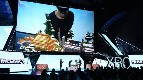 Lydia Winters, brand director for Mojang, and Saxs Persson, studio manager for Microsoft, show Minecraft built specifically for Microsoft HoloLens at E3 2015 on June 15 in Los Angeles.