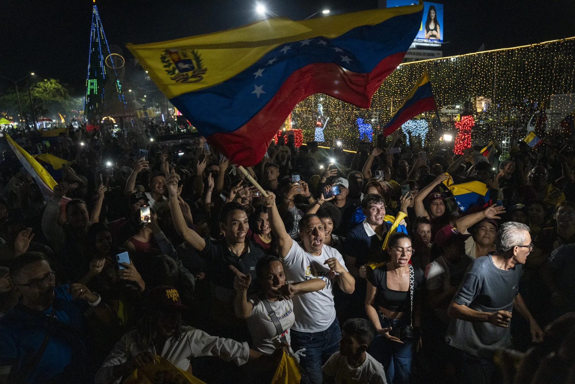 Venezuelan citizens celebrate during a rally after the confirmation of Nicolas Maduro's capture this early morning in Caracas, on Jan. 3.