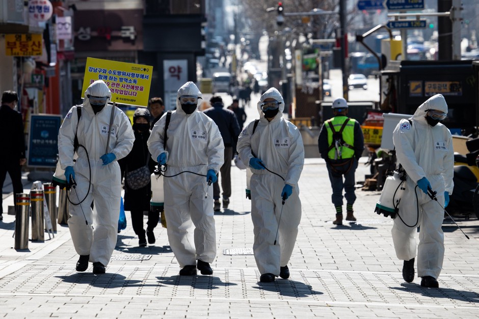 South Korean soldiers attempt to disinfect the sidewalks of Seoul's Gagnam district in response to the spread of COVID-19.