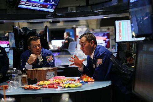 Traders wait on a nearly empty trading floor at the New York Stock Exchange (NYSE) after trading was halted due to a 'technical glitch' on July 8, 2015 in New York City.