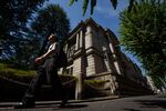 A pedestrian walks past the Bank of Japan (BOJ) headquarters in Tokyo, Japan.